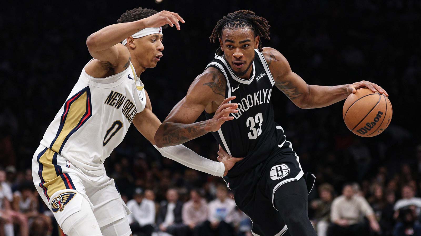 Brooklyn Nets center Nic Claxton (33) dribbles asNew Orleans Pelicans as New Orleans Pelicans guard Jeremiah Fears (0) defends during the second half at Barclays Center.