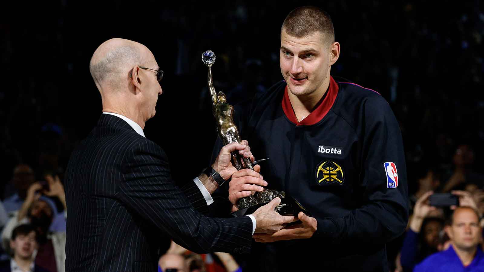 NBA commissioner Adam Silver presents Denver Nuggets center Nikola Jokic (15) the KIA NBA MVP trophy before game five against the Minnesota Timberwolves in the second round for the 2024 NBA playoffs at Ball Arena. 