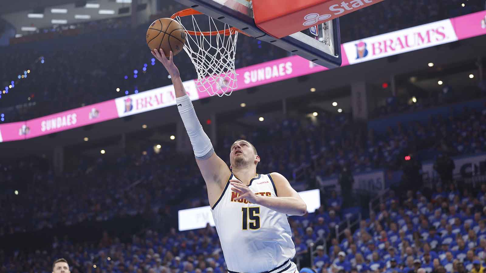 Denver Nuggets center Nikola Jokic (15) goes to the basket against the Oklahoma City Thunder in the first quarter during game seven of the second round for the 2025 NBA Playoffs at Paycom Center. 