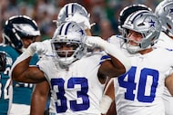 Dallas Cowboys running back Javonte Williams (33) flexes after scoring a touchdown during...
