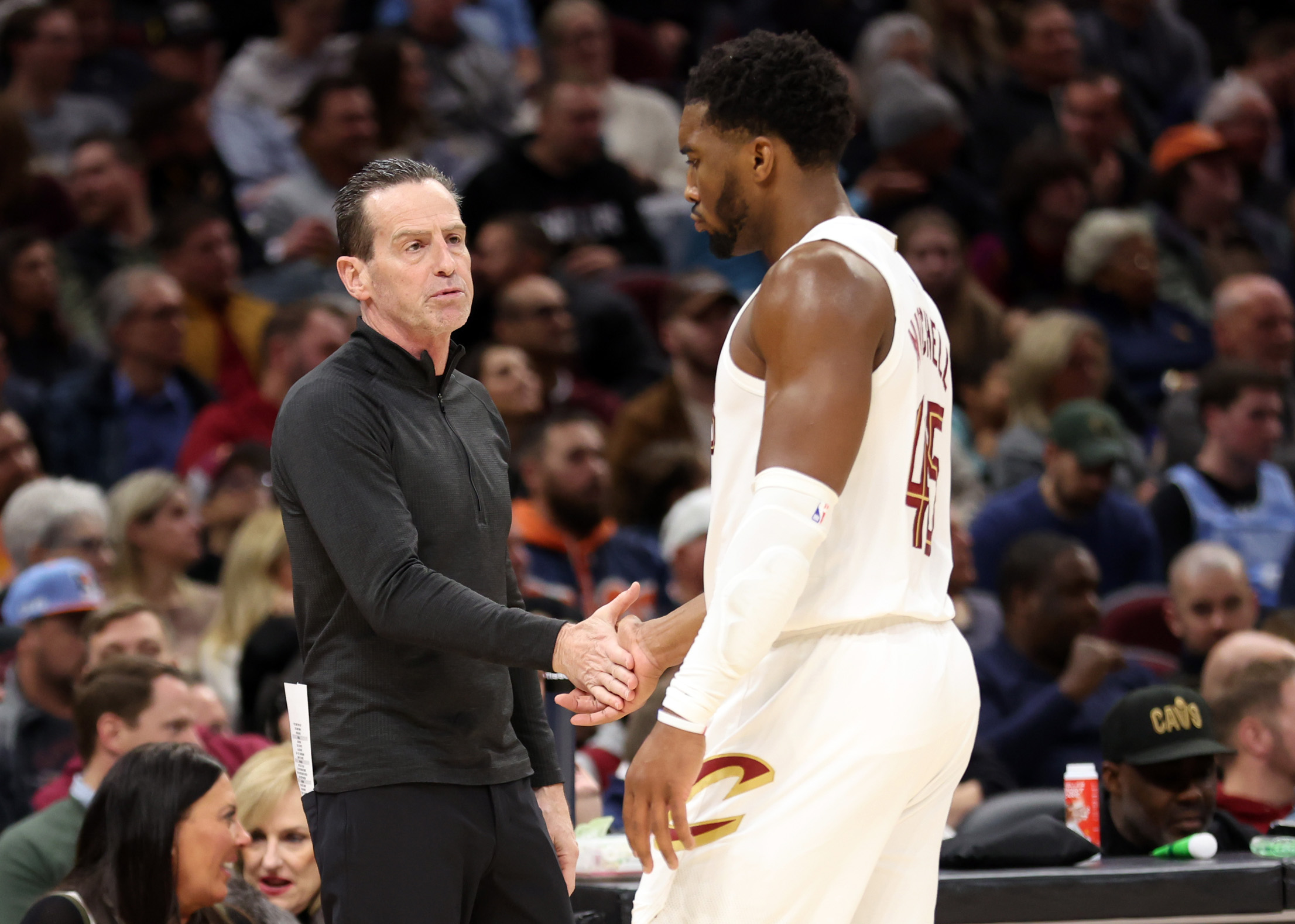 Cleveland Cavaliers head coach Kenny Atkinson talks to Cleveland Cavaliers guard Donovan Mitchell between plays against the Portland Trail Blazers in the second half of play. 