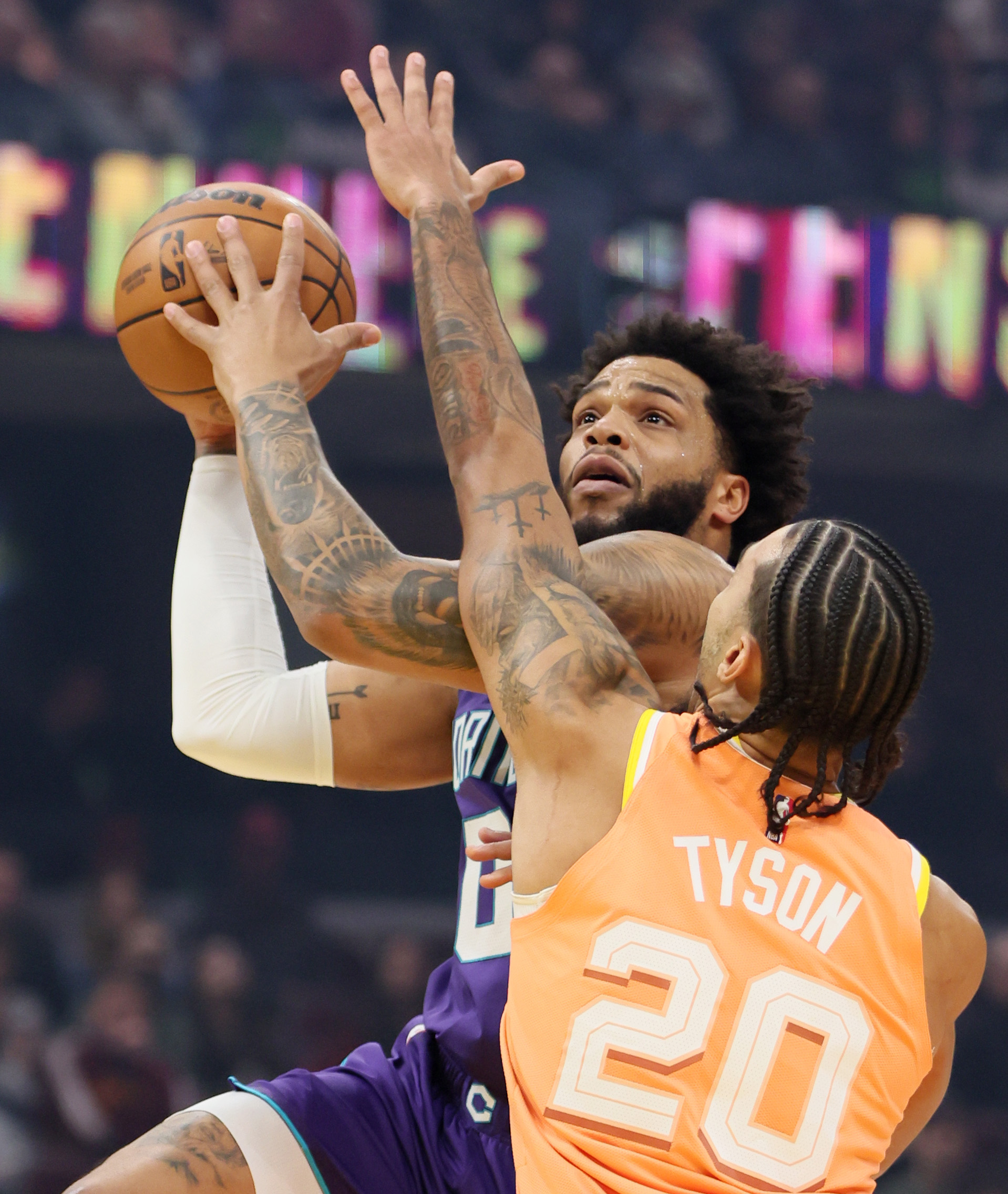 Charlotte Hornets forward Miles Bridges drives to the basket for a score guarded by Cleveland Cavaliers guard Jaylon Tyson in the first half at Rocket Arena. 