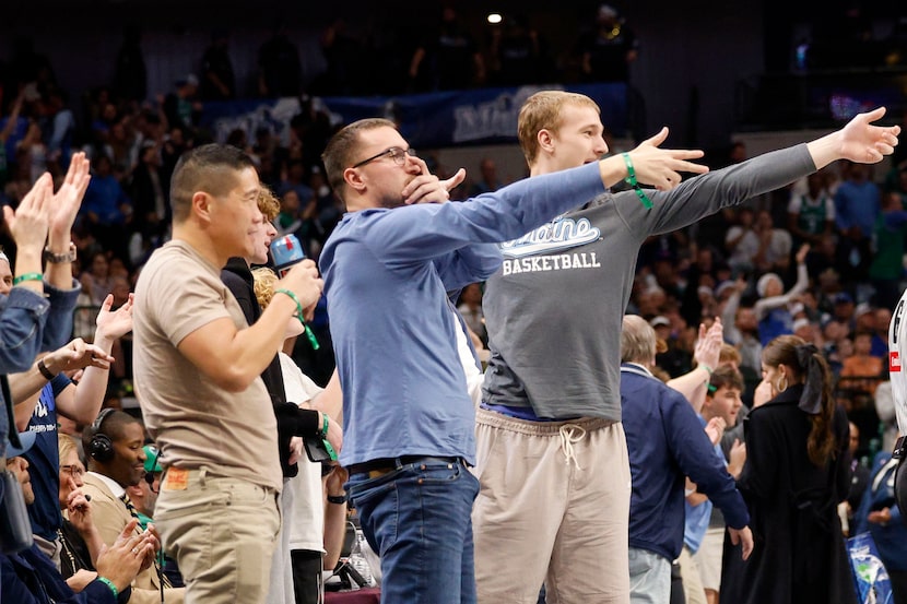 Dallas Mavericks forward Cooper Flagg’s brothers Hunter, center, and Ace, right, react after...