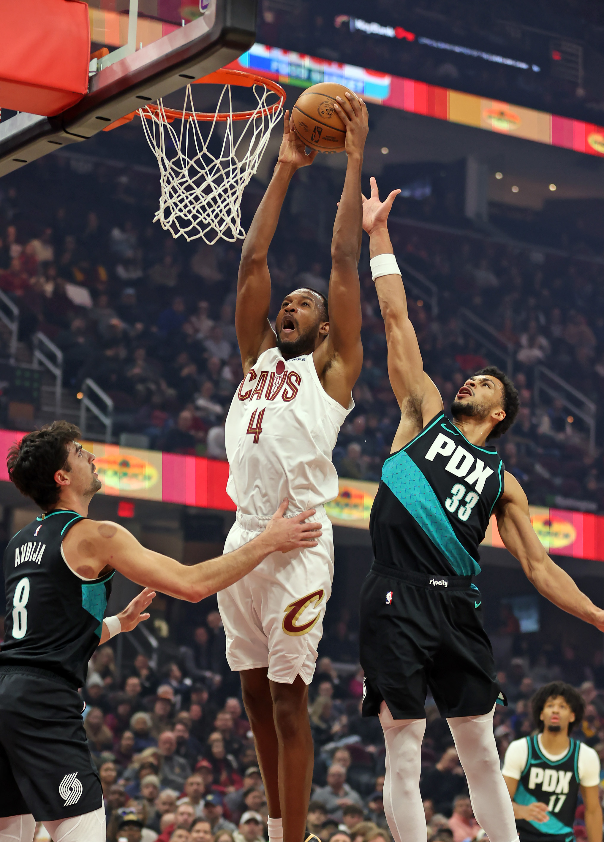 Cleveland Cavaliers center Evan Mobley hammers down a dunk over Portland Trail Blazers forward Toumani Camara in the first half of play. 