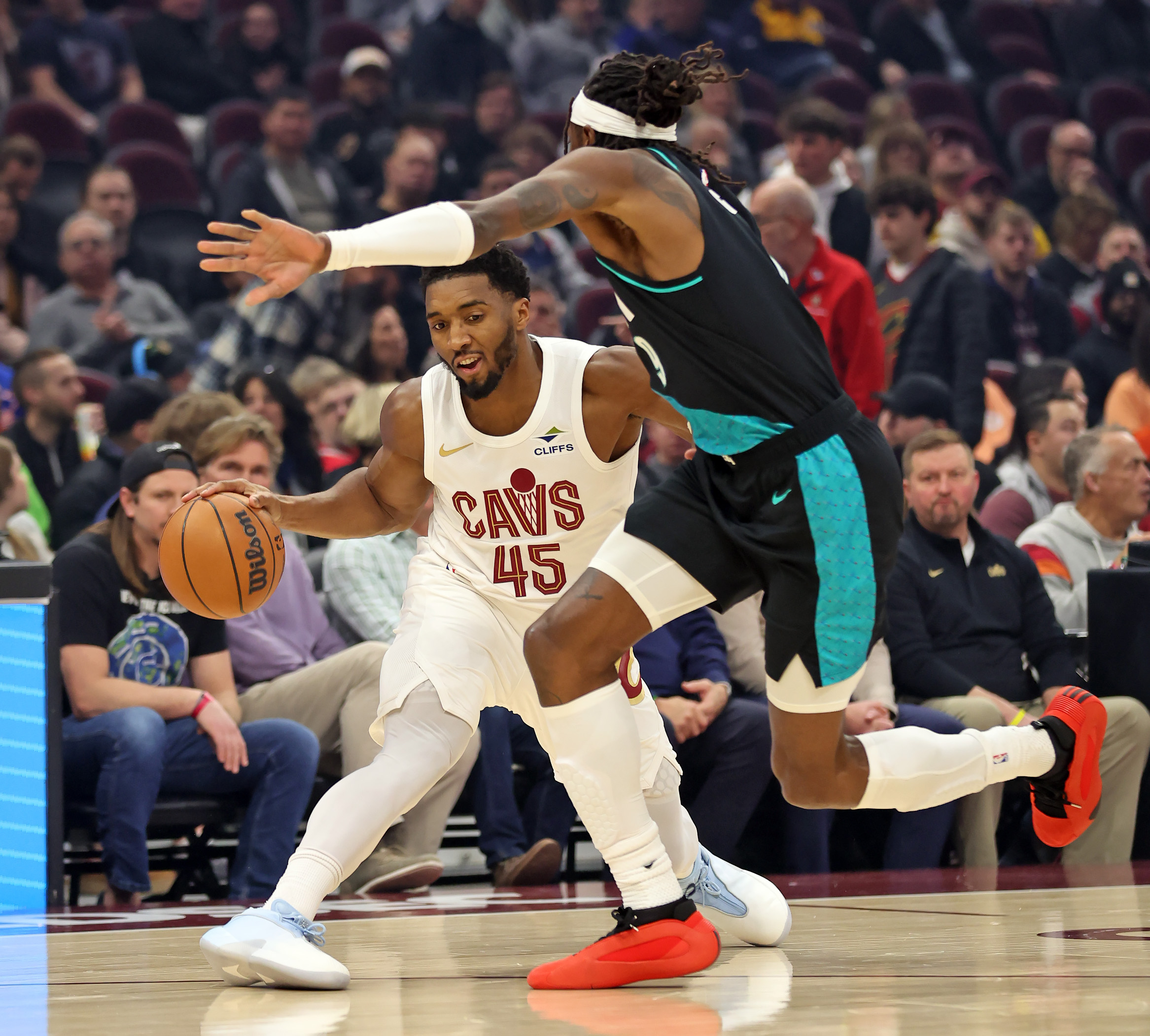 Cleveland Cavaliers guard Donovan Mitchell evades Portland Trail Blazers forward Jerami Grant in the first half of play. 