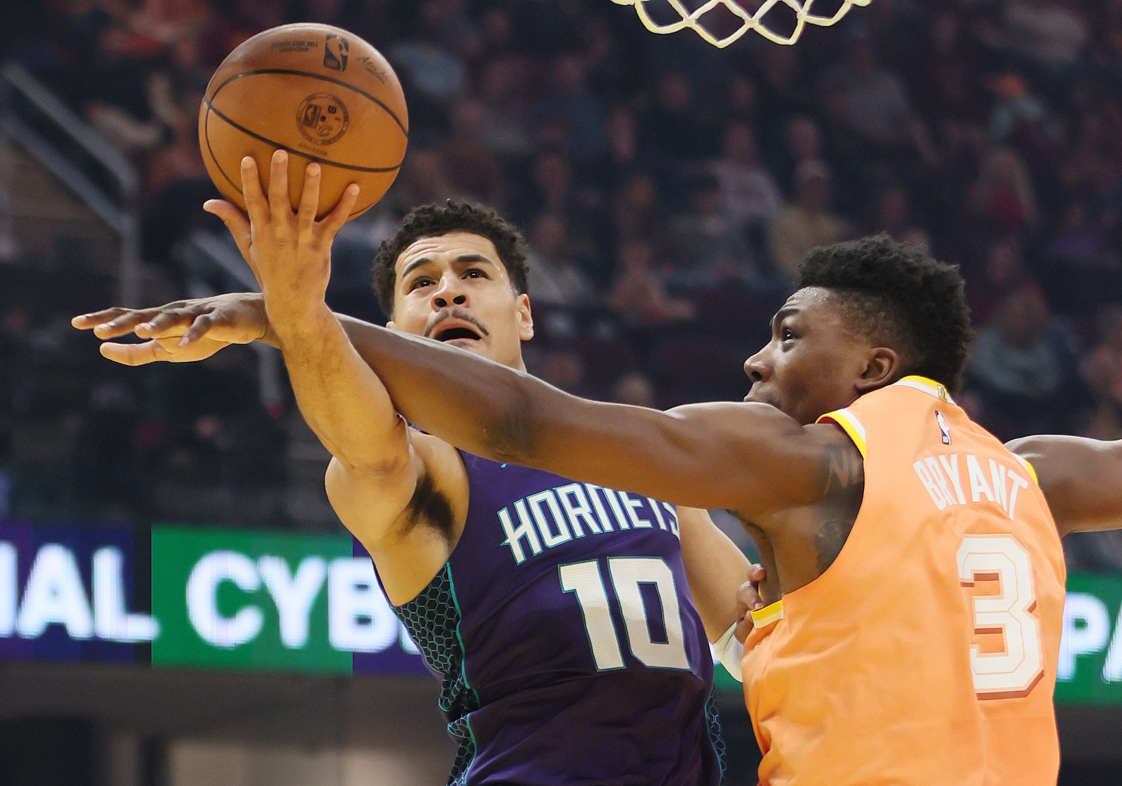 Charlotte Hornets guard Josh Green goes up for a layup attempt as he is fouled by Cleveland Cavaliers center Thomas Bryant in the first half at Rocket Arena. 