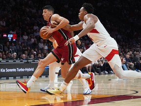 Miami Heat Simone Fontecchio (left) drives to the basket as Toronto Raptors forward Scottie Barnes, right, defends in Miami last night. Lynne Sladky/The Associated Press