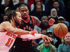 New York Knicks' Jalen Brunson (11) lines up a pass past Toronto Raptors' Jamal Shead (23) during their game on Tuesday. Sammy Kogan/The Canadian Press