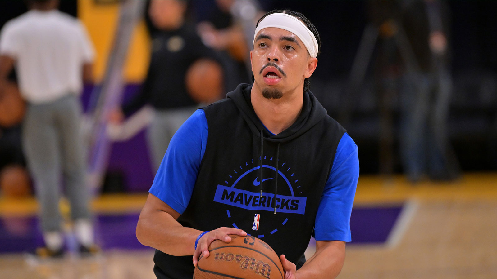 Dallas Mavericks guard Ryan Nembhard (9) warms up prior to the game against the Los Angeles Lakers at Crypto.com Arena. Mandatory Credit: Jayne Kamin-Oncea-Imagn Images