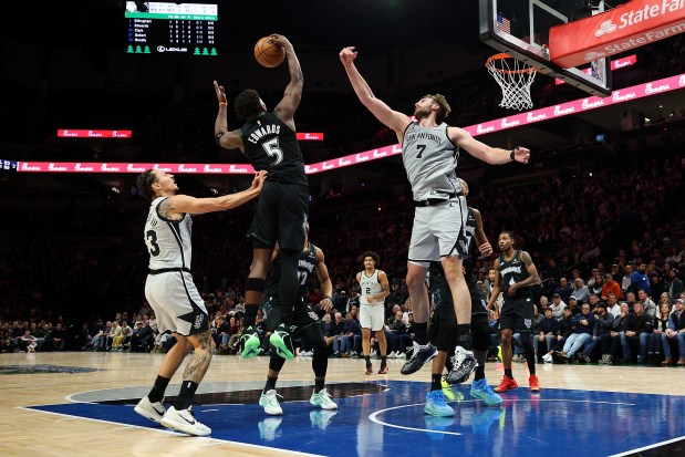 MINNEAPOLIS, MINNESOTA - NOVEMBER 30: Anthony Edwards #5 of the Minnesota Timberwolves rebounds the ball against Luke Kornet #7 of the San Antonio Spurs in the second quarter at Target Center on November 30, 2025 in Minneapolis, Minnesota. NOTE TO USER: User expressly acknowledges and agrees that, by downloading and or using this photograph, User is consenting to the terms and conditions of the Getty Images License Agreement. (Photo by David Berding/Getty Images)