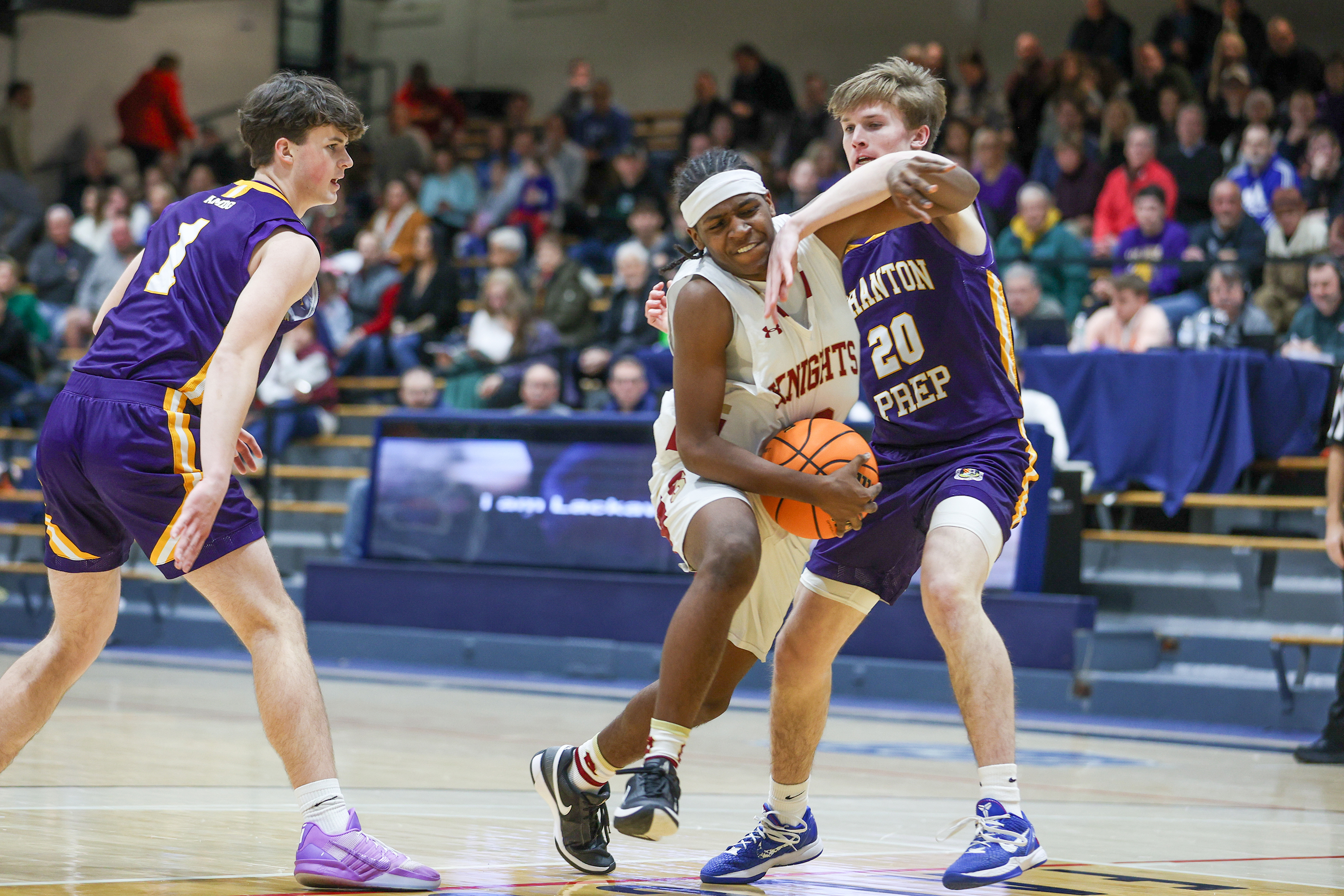 Scranton’s Justin Mayers (52) drives into Scranton Prep’s Packy Doherty...