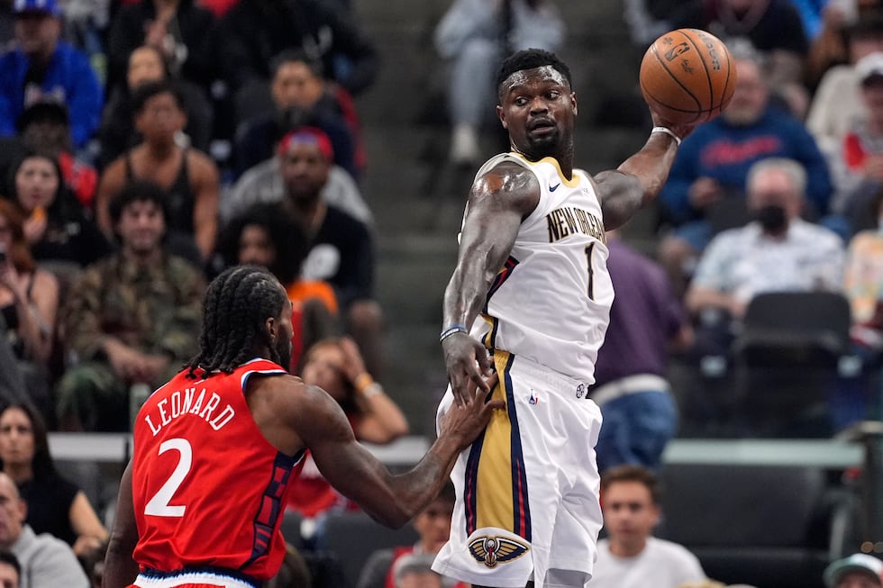 Pelicans forward Zion Williamson tries to pass while under pressure from the Los Angeles...