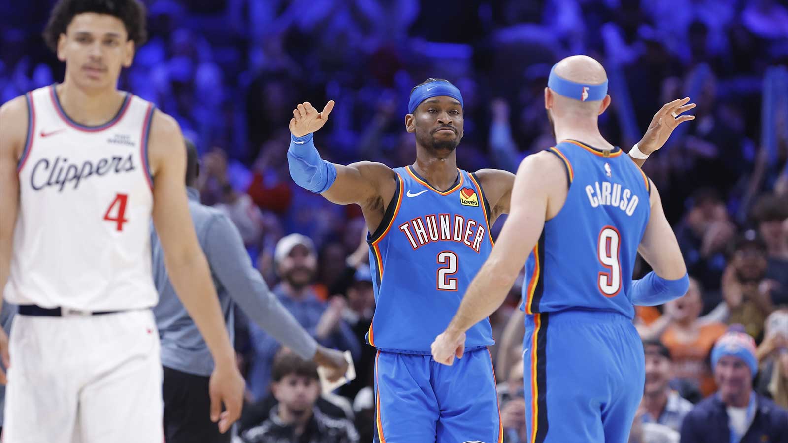 Oklahoma City Thunder guard Shai Gilgeous-Alexander (2) and guard Alex Caruso (9) celebrate after a play against the Los Angeles Clippers during the second half at Paycom Center. 