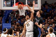 Dallas Mavericks forward Cooper Flagg (32) shoots over Denver Nuggets forward Spencer Jones...