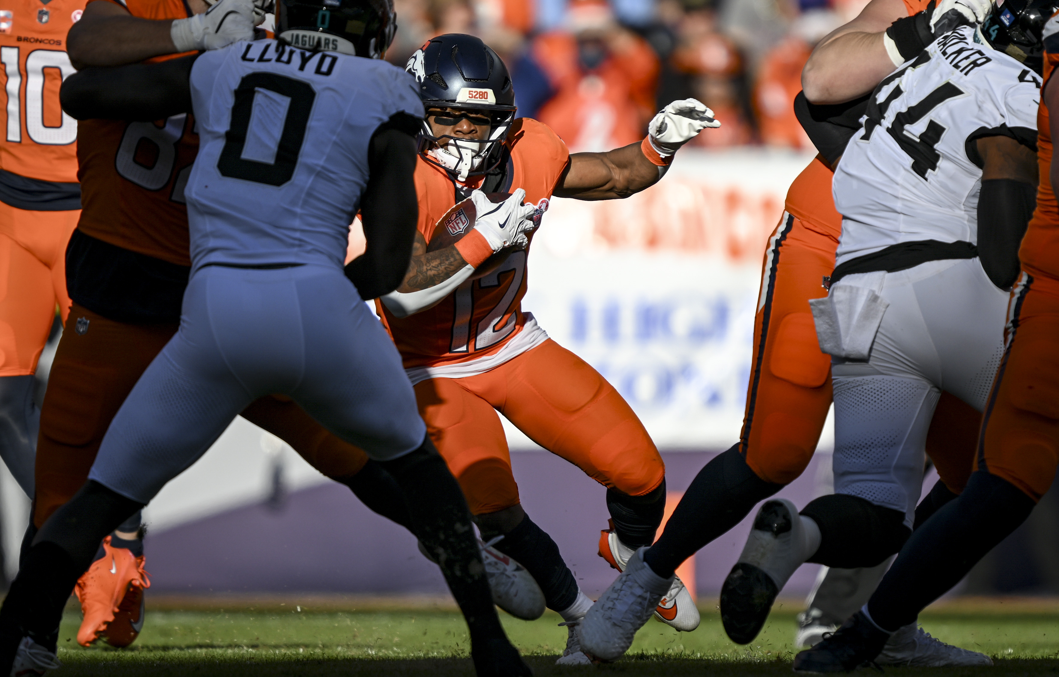 RJ Harvey (12) of the Denver Broncos looks for space...