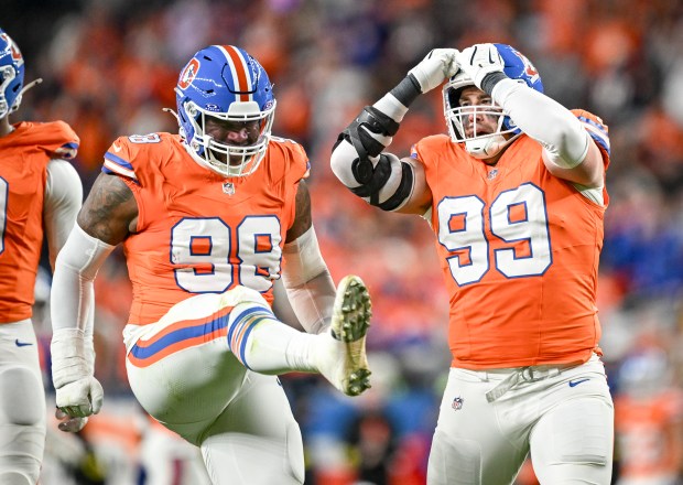 John Franklin-Myers (98) and Zach Allen (99) of the Denver Broncos celebrate a sack by Nik Bonitto (15) on Geno Smith (7) of the Las Vegas Raiders during the second quarter at Empower Field at Mile High Stadium on Thursday, Nov. 6, 2025. (Photo by AAron Ontiveroz/The Denver Post)