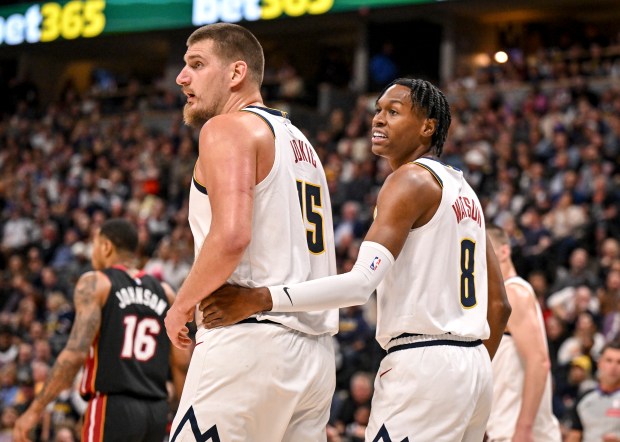 Peyton Watson (8) of the Denver Nuggets puts his hand on the hip of Nikola Jokic (15) after blocking a shot during the third quarter of the Nuggets' 122-112 win over the Miami Heat at Ball Arena in Denver on Wednesday, Nov. 5, 2025. (Photo by AAron Ontiveroz/The Denver Post)