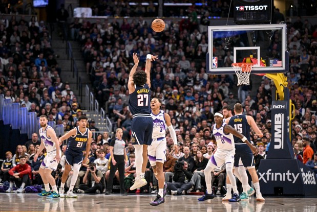 Jamal Murray (27) of the Denver Nuggets makes a three pointer over Keyonte George (3) of the Utah Jazz during the second quarter at Ball Arena in Denver, Colorado on Monday, Dec. 22, 2025. (Photo by AAron Ontiveroz/The Denver Post)