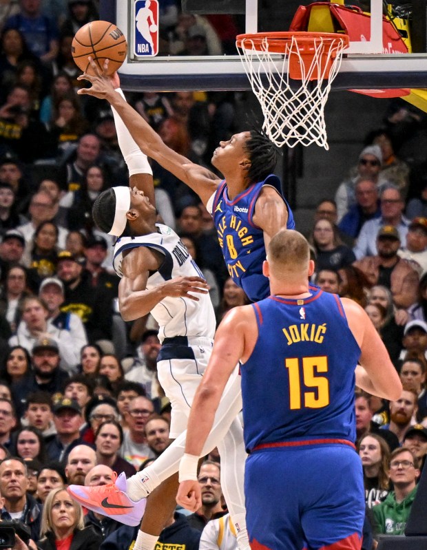 DENVER , CO - DECEMBER 1: Peyton Watson (8) of the Denver Nuggets blocks Brandon Williams (10) of the Dallas Mavericks during the first quarter at Ball Arena in Denver, Colorado on Monday, December 1, 2025. (Photo by AAron Ontiveroz/The Denver Post)