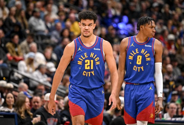 DENVER , CO - DECEMBER 1: Spencer Jones (21) and Peyton Watson (8) of the Denver Nuggets take the court during the second quarter against the Dallas Mavericks at Ball Arena in Denver, Colorado on Monday, December 1, 2025. (Photo by AAron Ontiveroz/The Denver Post)