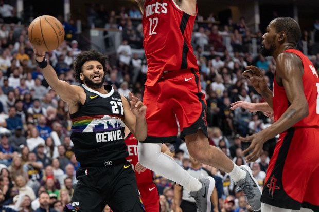 Denver Nuggets guard Jamal Murray (27) passes while being defended by Houston Rockets center Steven Adams (12) during the second half on Saturday, Dec. 20, 2025, at Ball Arena in Denver. (Photo by Timothy Hurst/The Denver Post)