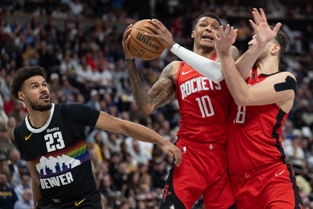 Houston Rockets forward Jabari Smith Jr. (10) center Alperen Sengun (28) come down with an offensive rebound over Denver Nuggets forward Cameron Johnson (23) on Saturday, Dec. 20, 2025, at Ball Arena in Denver. (Photo by Timothy Hurst/The Denver Post)