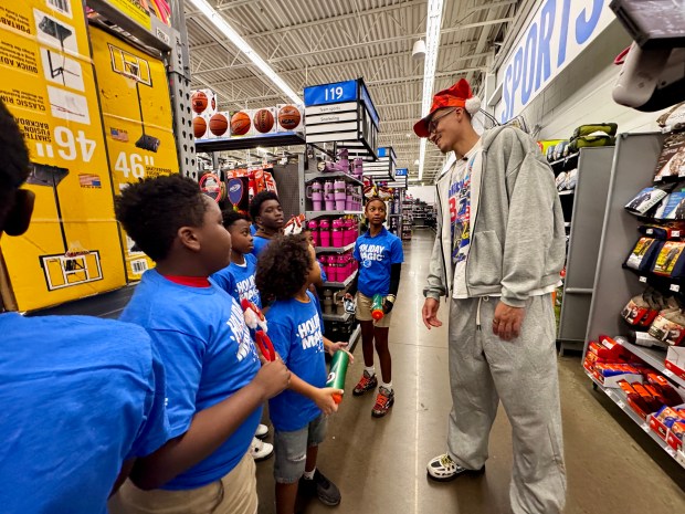 Magic forward Tristan da Silva chats with kids from the Boys and Girls Clubs of Central during a holiday shopping spree at a Walmart in Orlando on Thursday night. (Jason Beede/Orlando Sentinel)