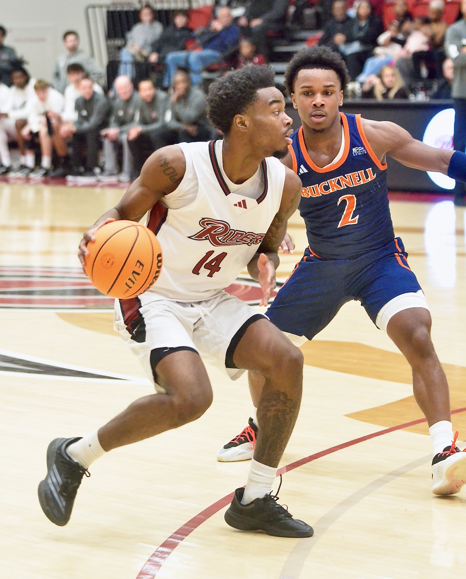 Rider’s Antwan Wilson, left, moves toward the basket as Bucknell’s...
