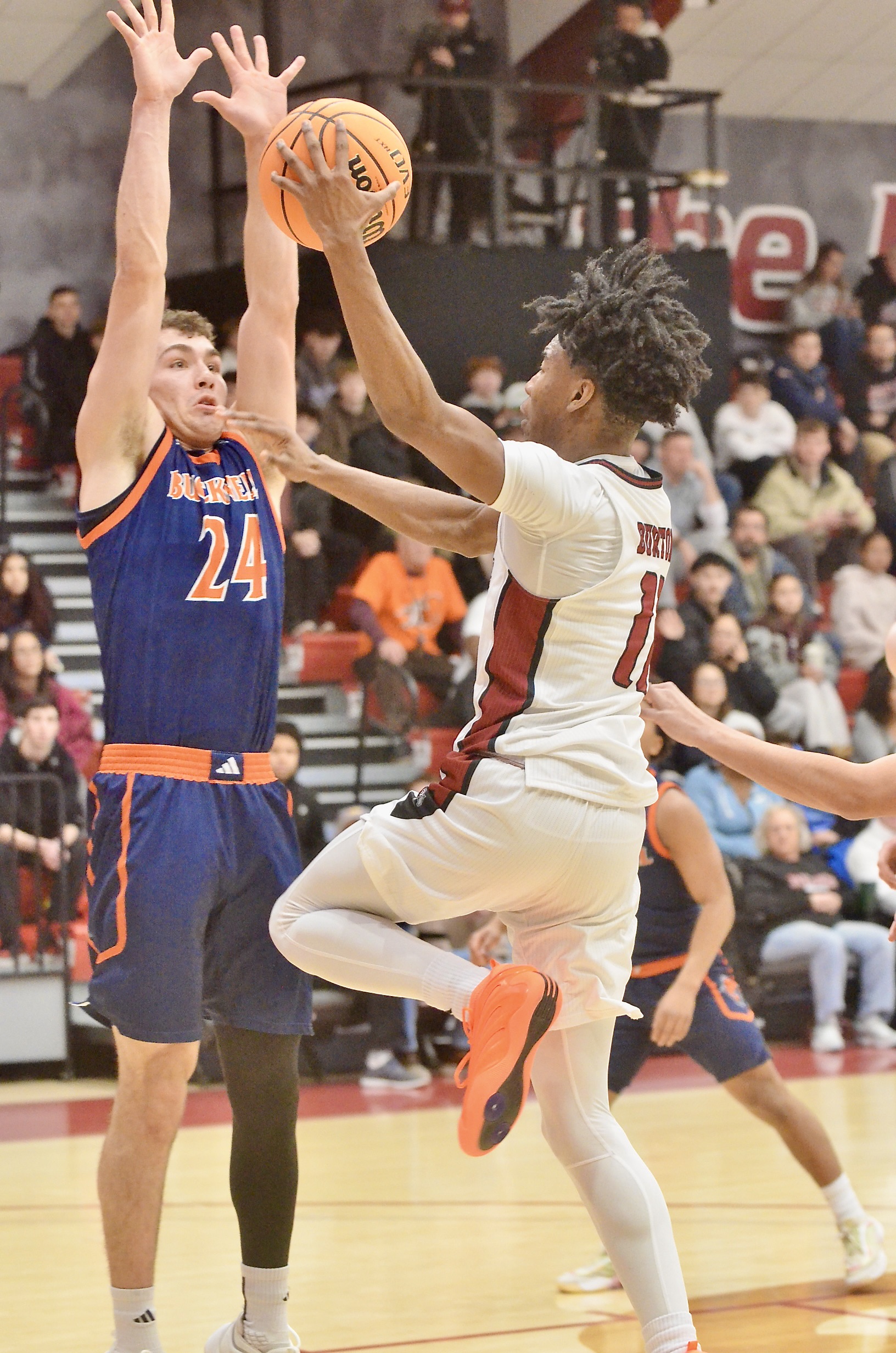 Rider’s Flash Burton, 11, goes up for a shot as...