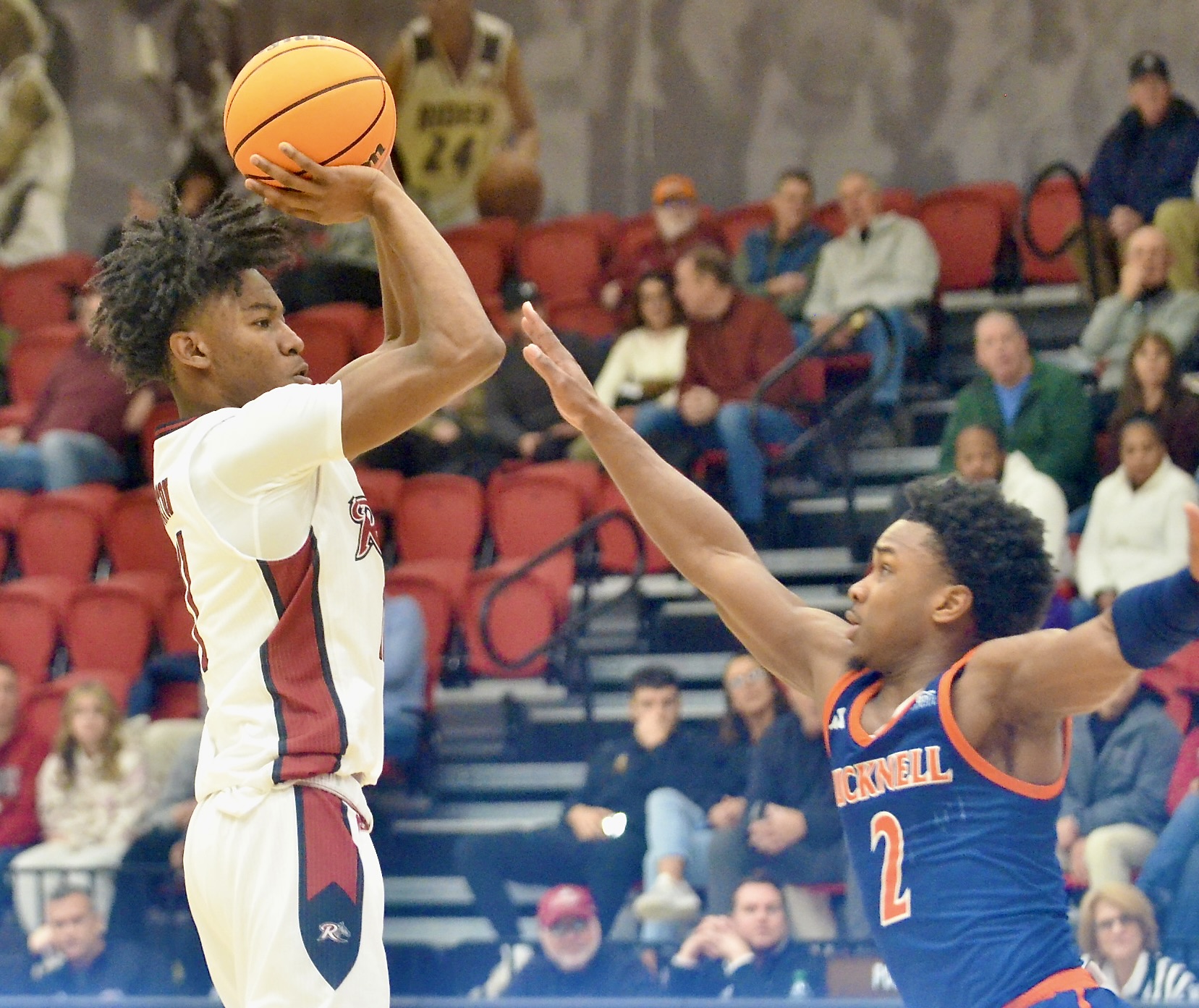 Rider’s Flash Burton, left, shoots over the defense of Bucknell’s...
