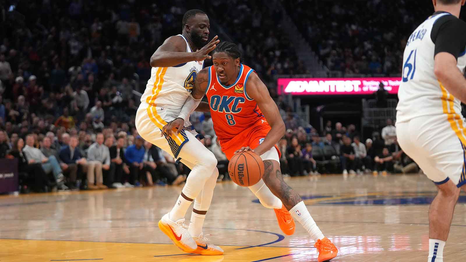 Thunder guard Jalen Williams (8) dribbles past Golden State Warriors forward Draymond Green (23) in the fourth quarter at the Chase Center