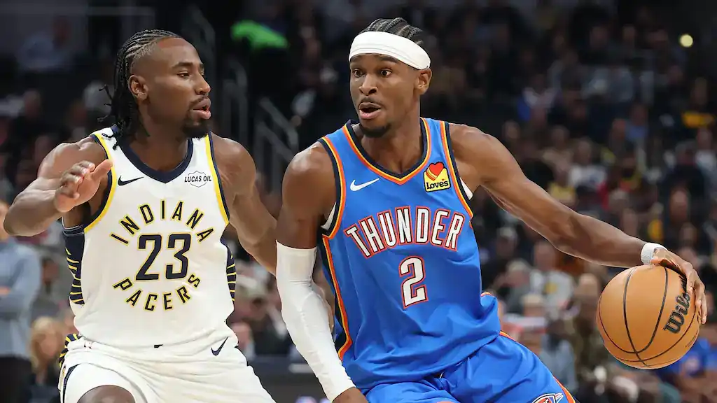 Oklahoma City Thunder vs San Antonio Spurs Picks and Predictions December 13th 2025 2 Indiana Pacers player wearing jersey number 23 defends against Oklahoma City Thunder's number 2, who is dribbling the basketball while driving toward the basket during an NBA game.