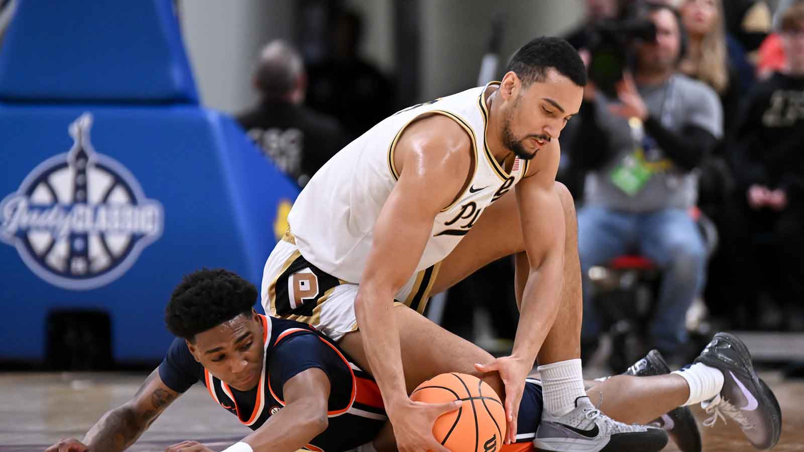 Purdue Boilermakers forward Trey Kaufman-Renn (4) and Auburn Tigers guard Tahaad Pettiford (0) go after a loose ball during the first half at Gainbridge Fieldhouse. 