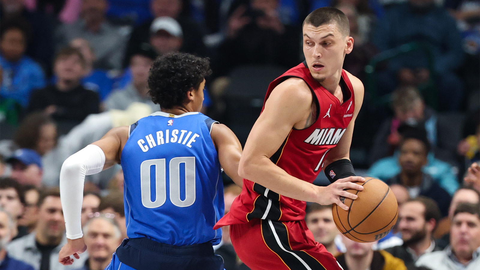 Miami Heat guard Tyler Herro (14) controls the ball as Dallas Mavericks guard Max Christie (00) defends during the first quarter at American Airlines Center.