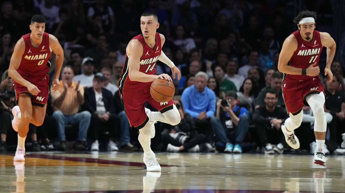 Miami Heat guard Tyler Herro (14) brings the ball up the court against the Dallas Mavericks in the first half at Kaseya Center.