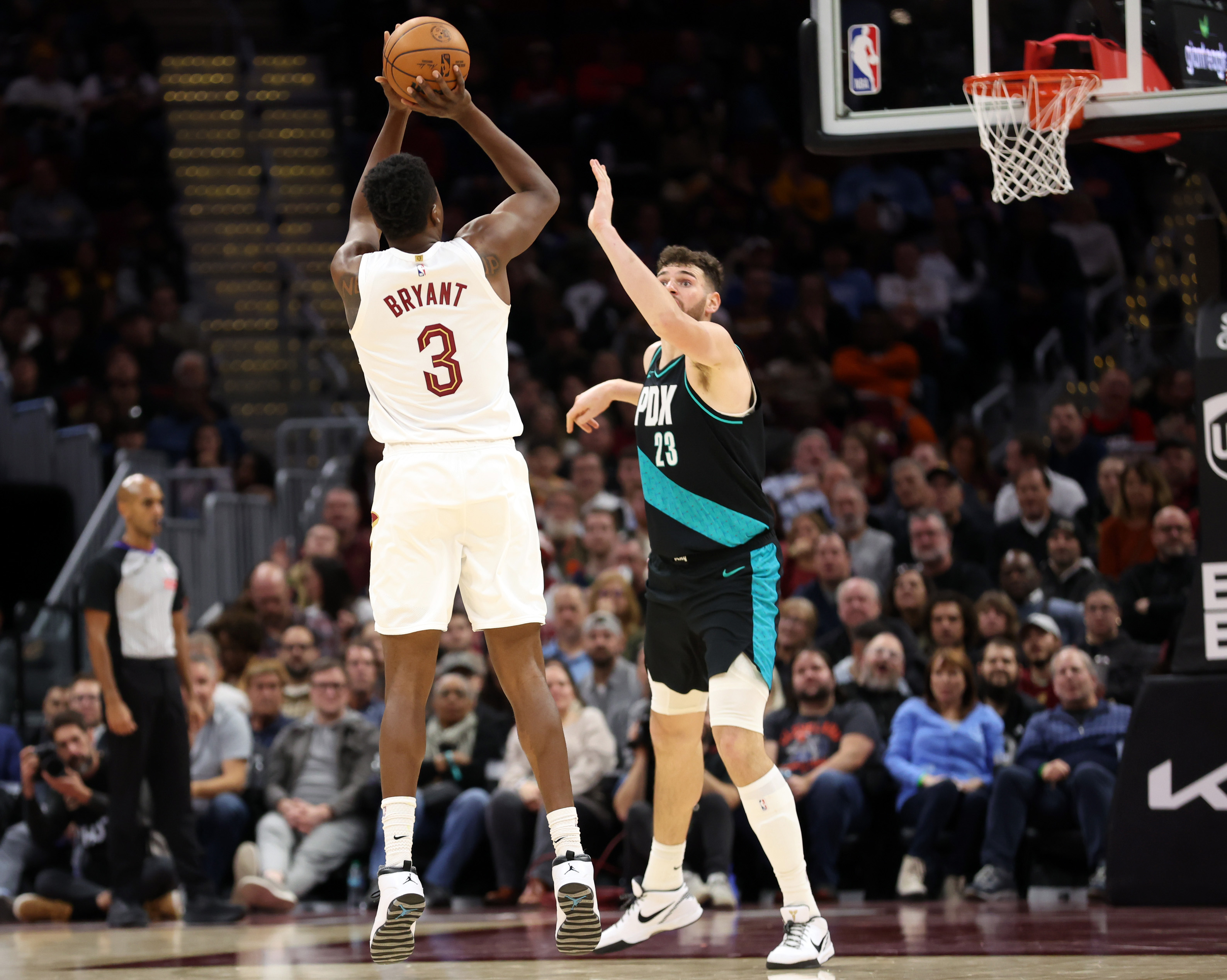Cleveland Cavaliers center Thomas Bryant drains a three over Portland Trail Blazers center Donovan Clingan in the second half of play. 