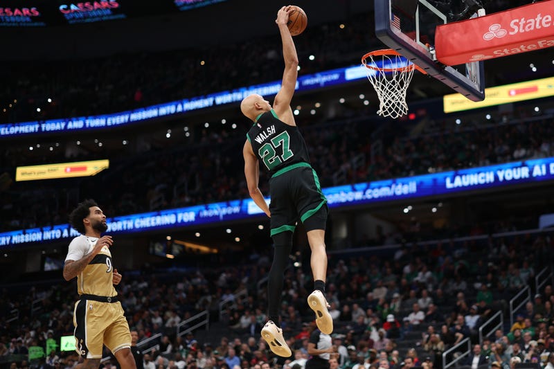 Boston Celtics guard Jordan Walsh (27) dunks the ball as Washington Wizards forward Justin Champagnie (9) looks on in the first half at Capital One Arena.