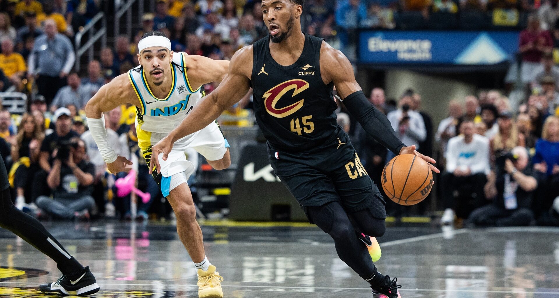 May 11, 2025; Indianapolis, Indiana, USA; Cleveland Cavaliers guard Donovan Mitchell (45) dribbles the ball while Indiana Pacers guard Andrew Nembhard (2) defends during game four of the second round for the 2025 NBA Playoffs at Gainbridge Fieldhouse. Mandatory Credit: Trevor Ruszkowski-Imagn Images