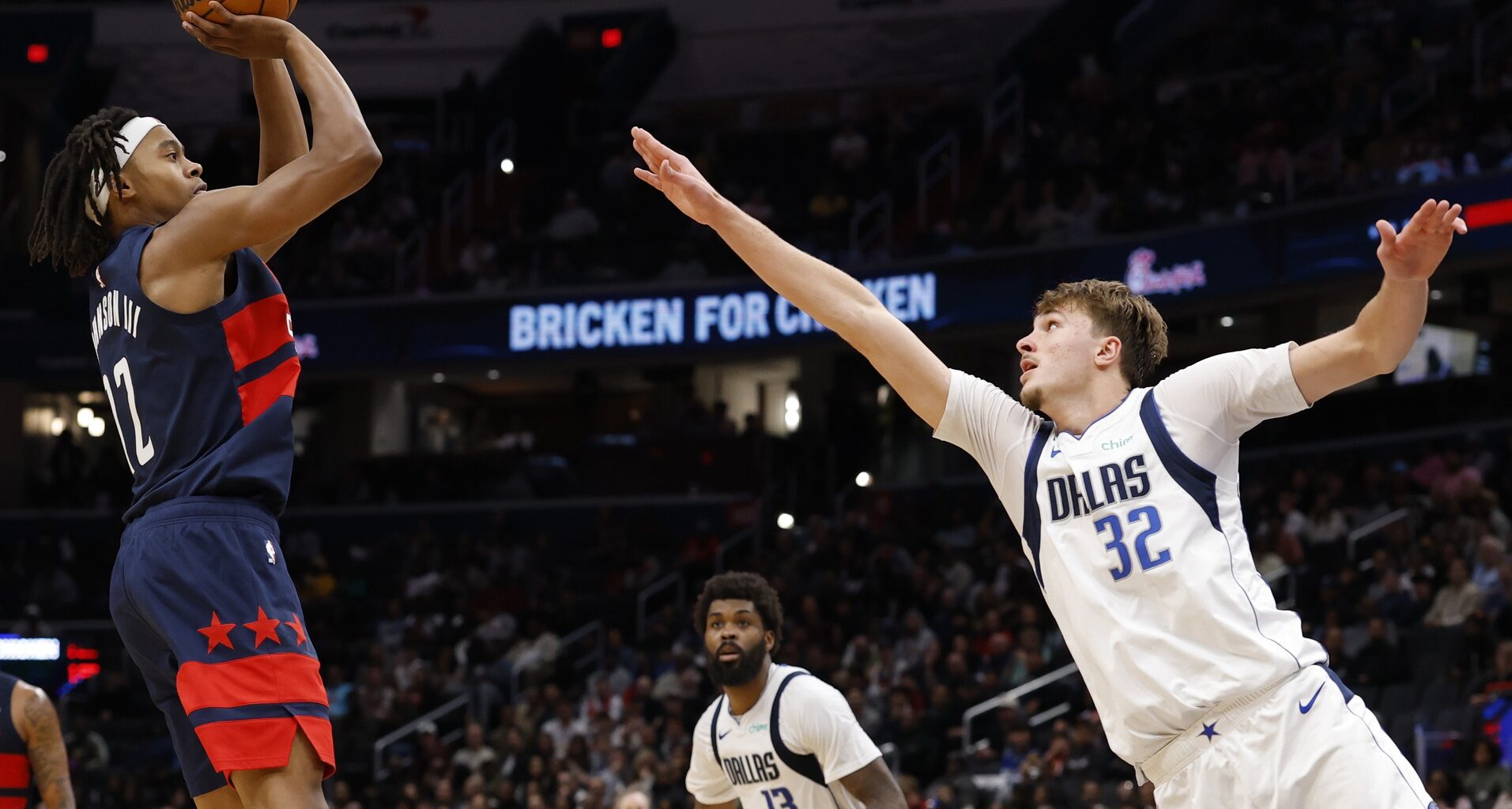 Nov 8, 2025; Washington, District of Columbia, USA; Washington Wizards guard Tre Johnson (12) shoots the ball over Dallas Mavericks forward Cooper Flagg (32) in the second half at Capital One Arena. Mandatory Credit: Geoff Burke-Imagn Images
