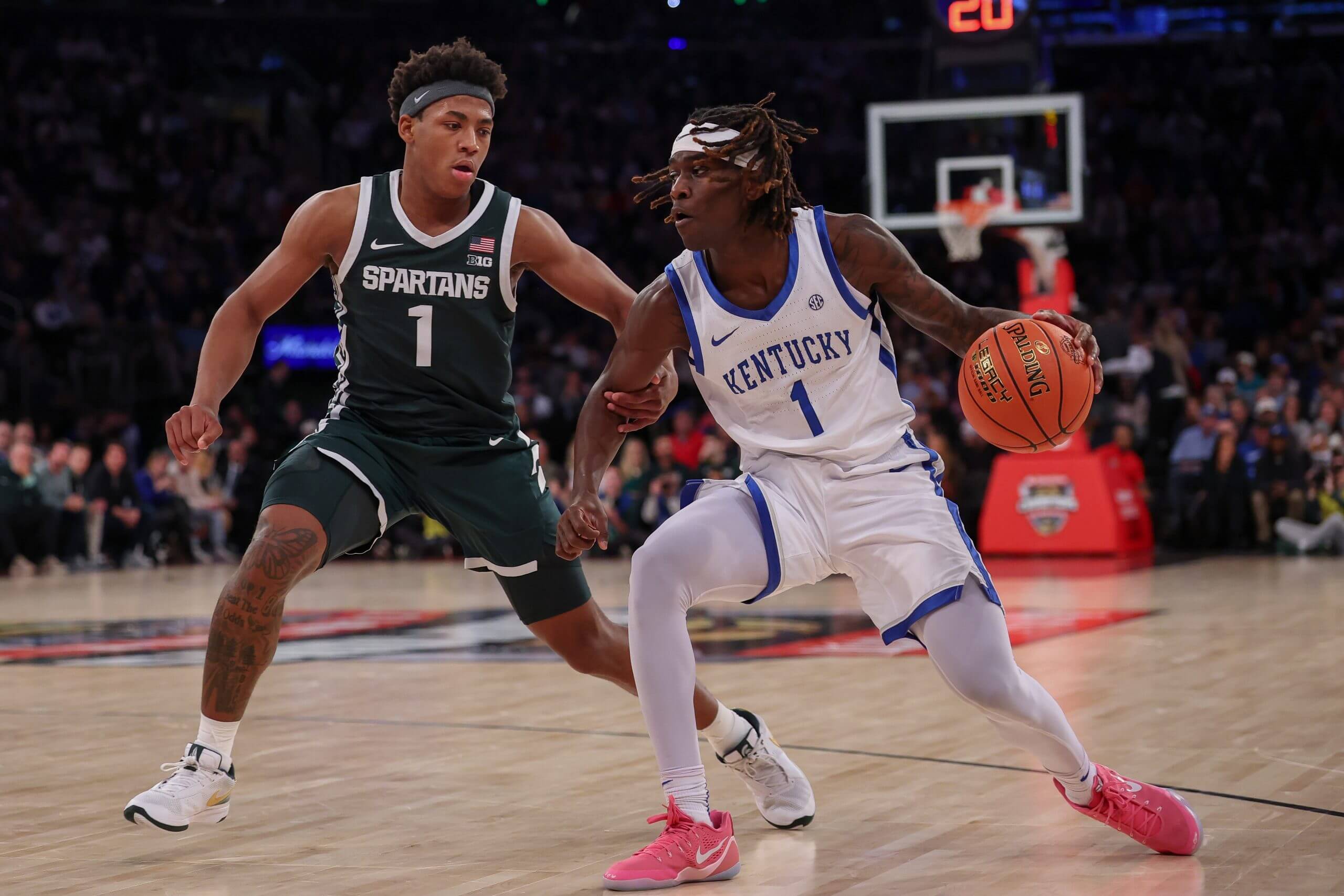 Denzel Aberdeen dribbles with his left hand against Jeremy Fears Jr.