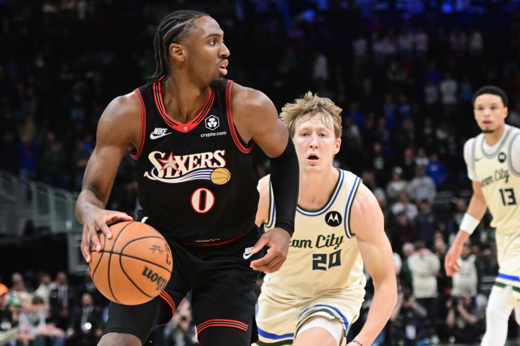 Nov 20, 2025; Milwaukee, Wisconsin, USA; Philadelphia 76ers guard Tyrese Maxey (0) looks for a shot against Milwaukee Bucks guard AJ Green (20) in the first overtime at Fiserv Forum.