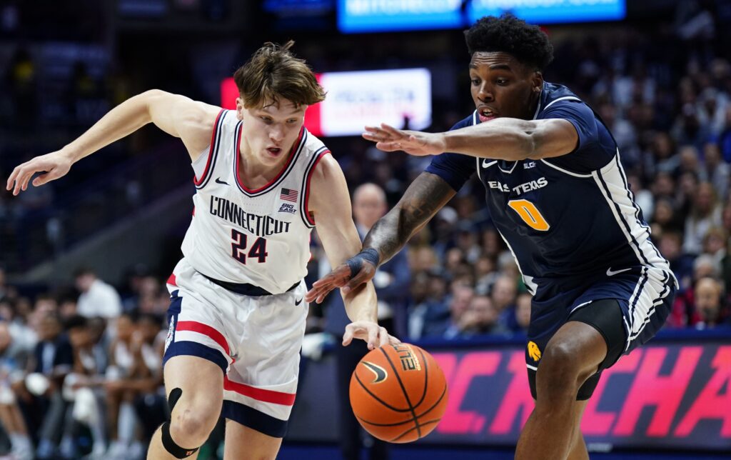 UConn Huskies guard Braylon Mullins (24) and East Texas A&M Lions forward Ronnie Harrison (0) work for the ball in the first half at Harry A. Gampel Pavilion.