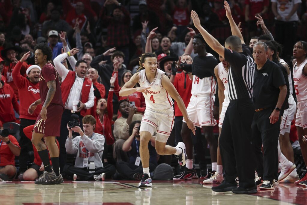 Houston Cougars guard Kingston Flemings (4) celebrates after making a basket during the second half against the Florida State Seminoles at Toyota Center.