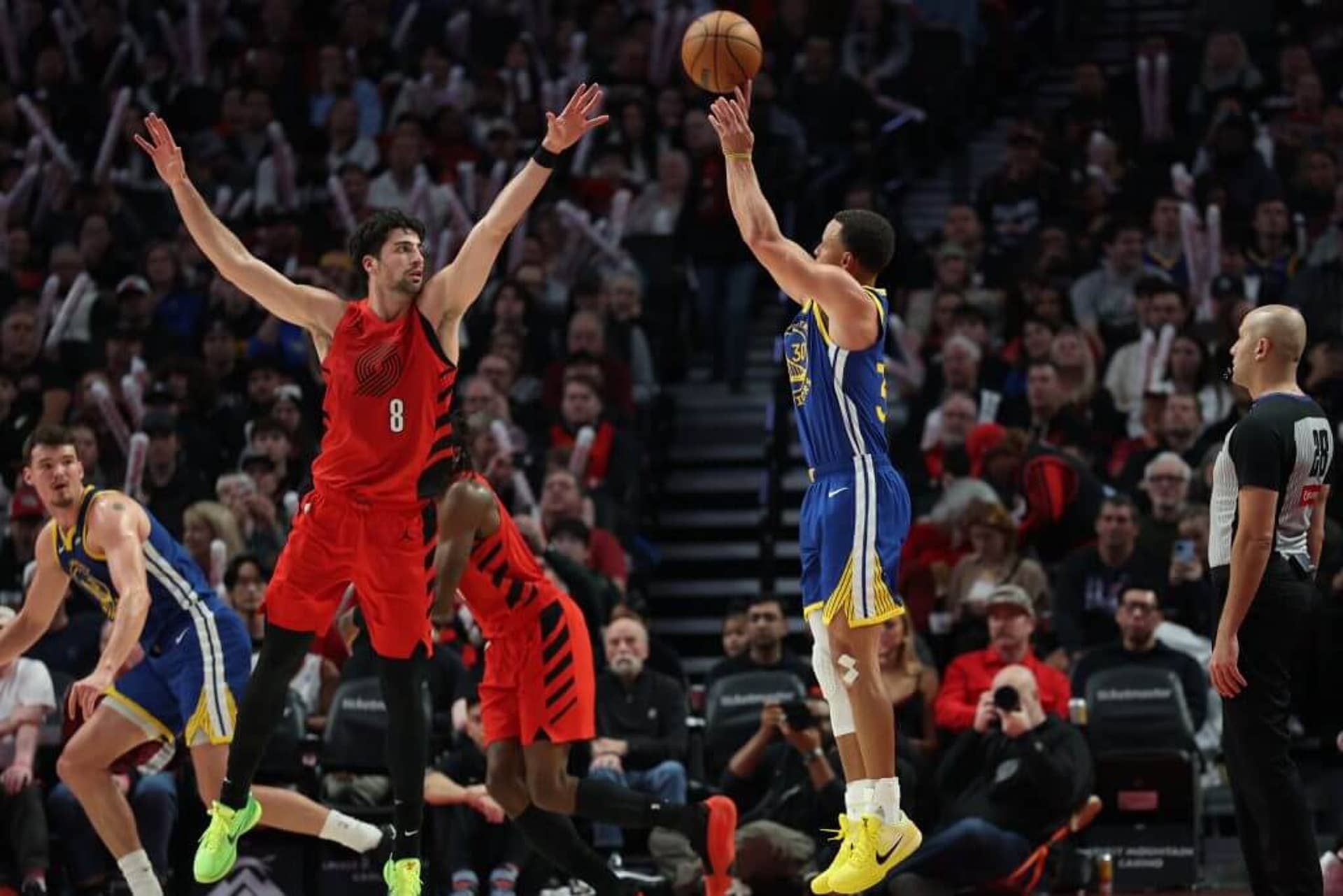 Steph Curry shoots a 3-pointer during a Warriors-Blazers game.