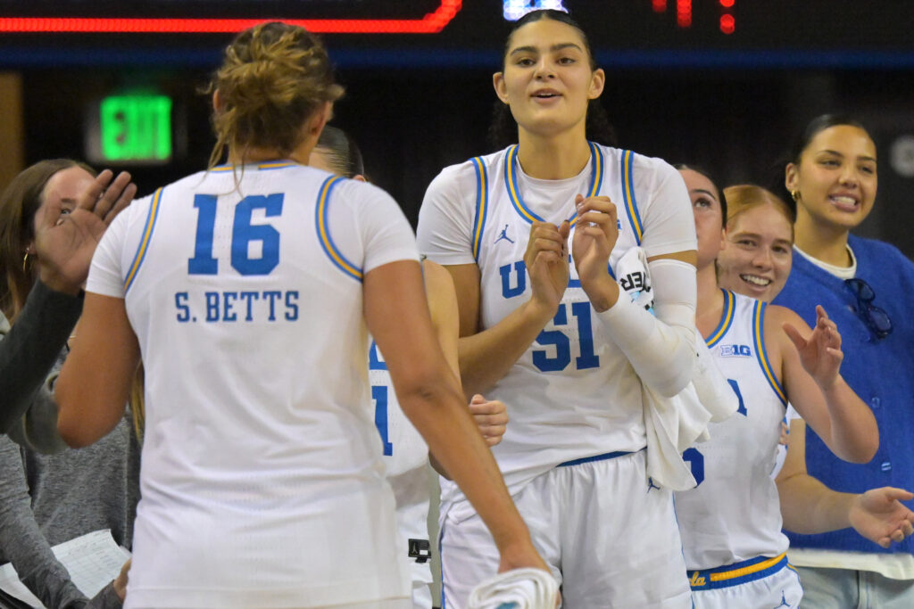 UCLA Bruins forward Sienna Betts congratulated by sister Lauren Betts