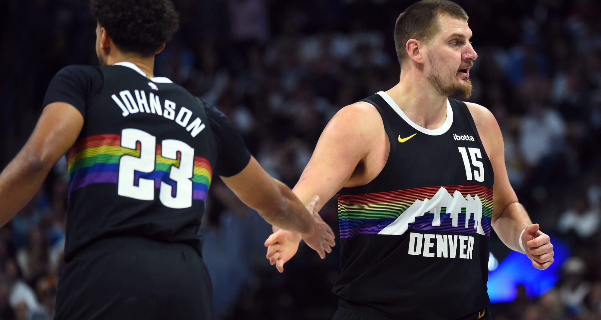 Nuggets superstar Nikola Jokic high fives Cam Johnson in a game against the Rockets during the 2025-26 NBA season.