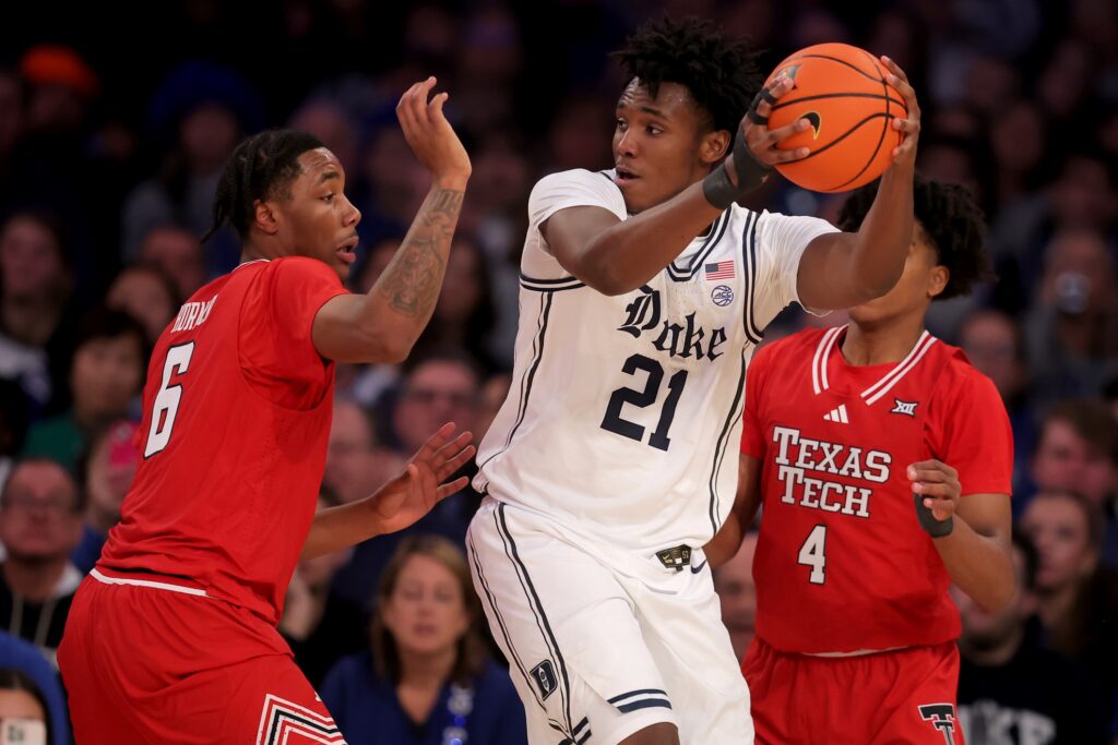 Duke Blue Devils center Patrick Ngongba II (21) controls the ball against Texas Tech Red Raiders guards Leon Horner (6) and Christian Anderson (4) during the second half at Madison Square Garden.