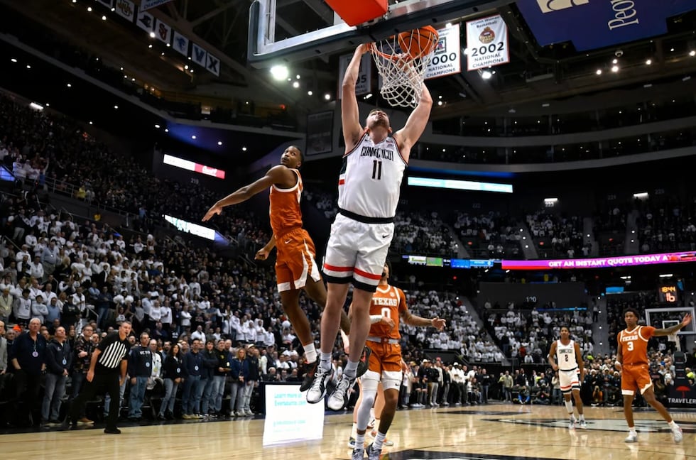 UConn forward Alex Karaban (11) dunks in the first half of an NCAA college basketball game...