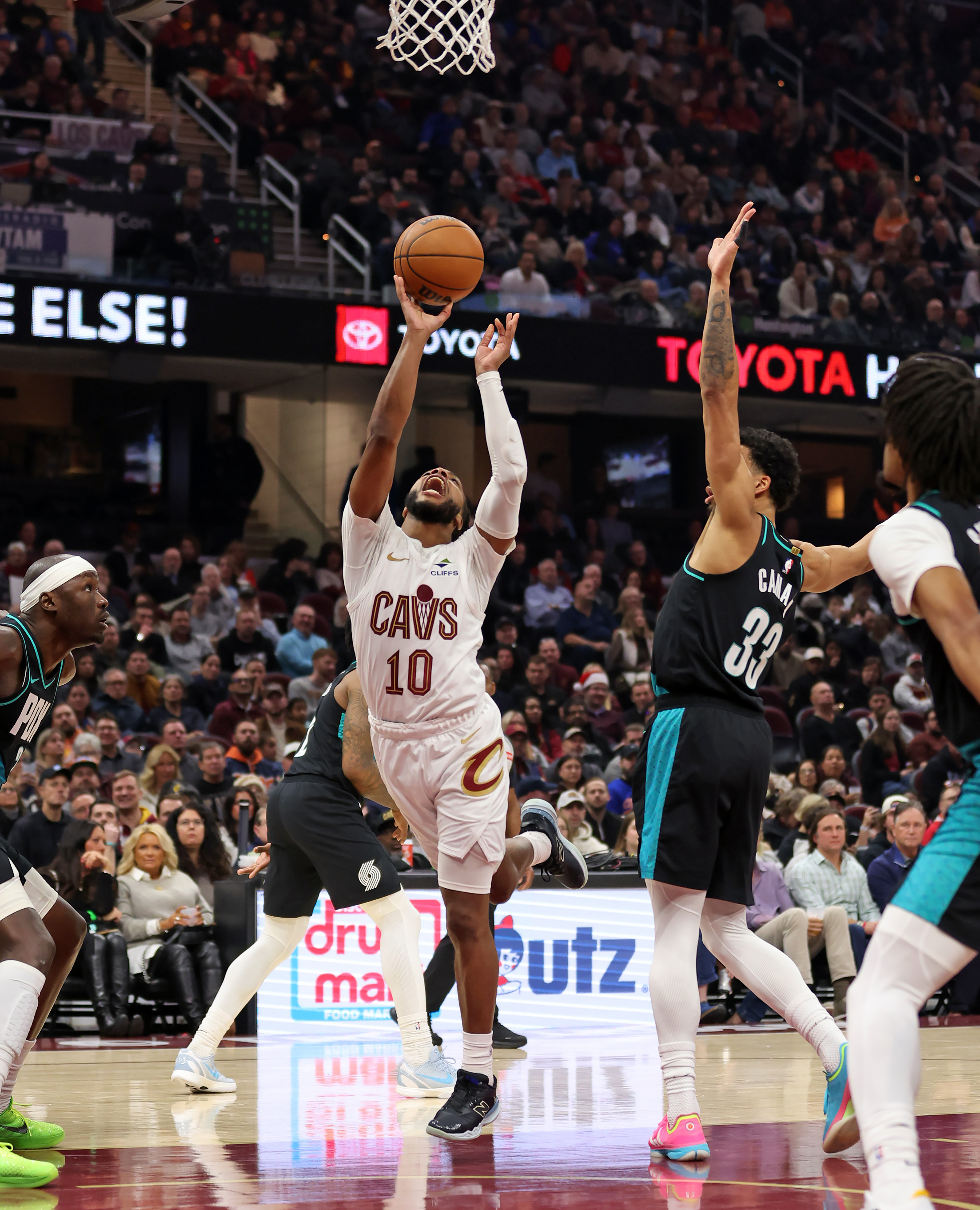 Cleveland Cavaliers guard Darius Garland shoots after colliding with Portland Trail Blazers forward Toumani Camara in the first half of play. 