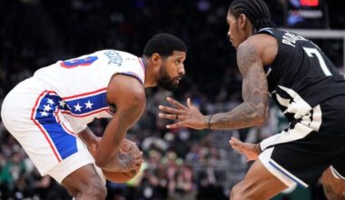 Paul George stares down Milwaukee Bucks guard Kevin Porter Jr. on Friday at Fiserv Forum.